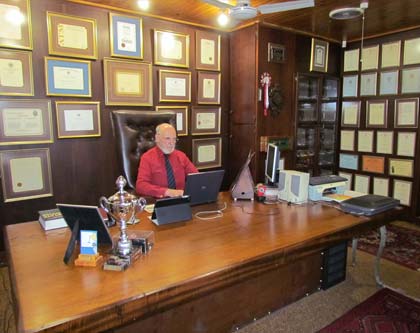 A photo of Leon's study with some of his qualifications in the background